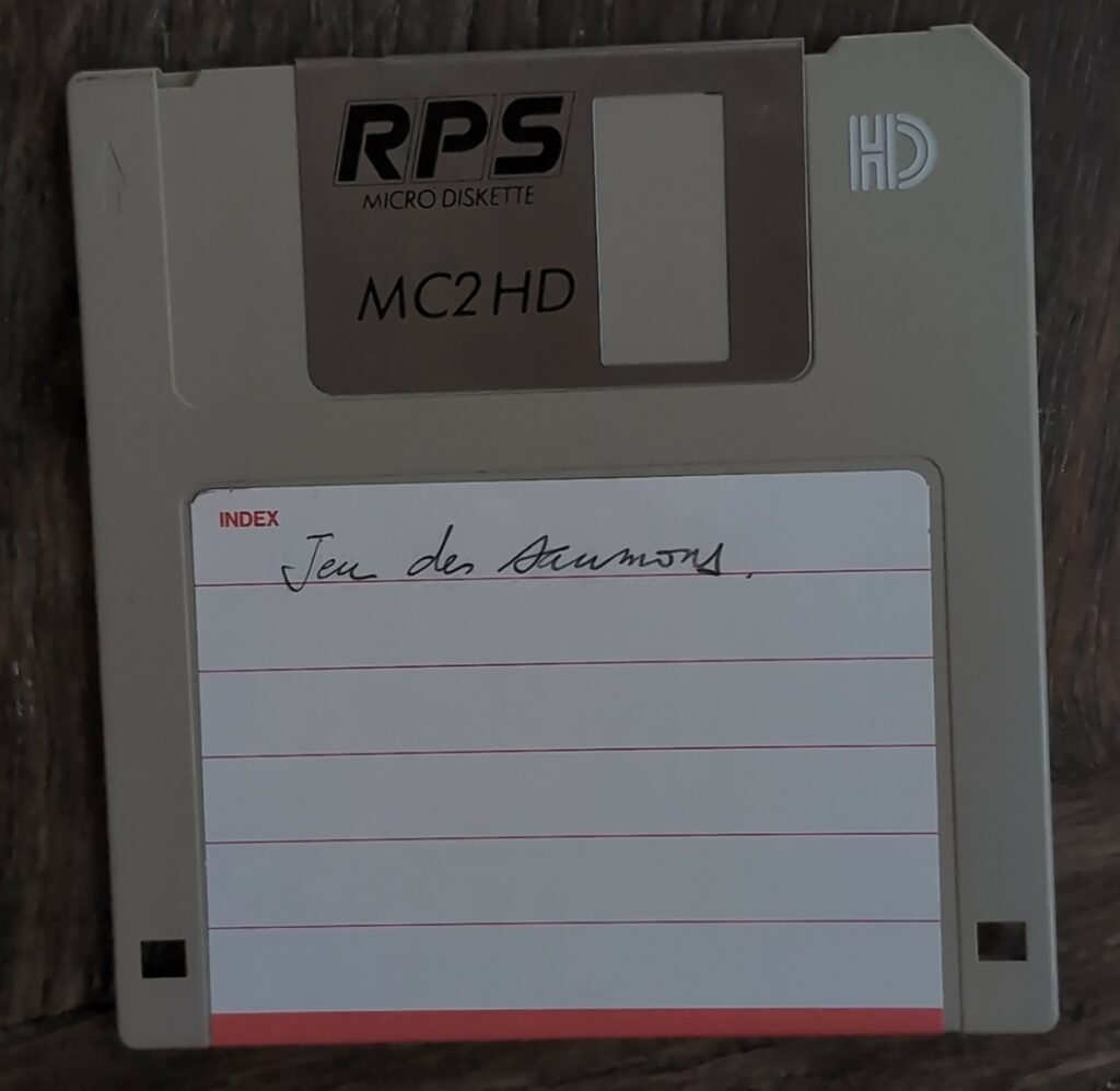 Photo d'une disquette HD grise, de marque RPS, avec une étiquette qui porte les mots manuscrits "Jeu des saumons". 